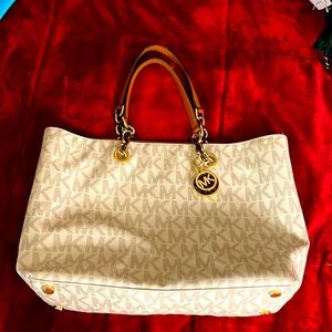 Michael Kors bag worn couple times, has a makeup stain on a corner.